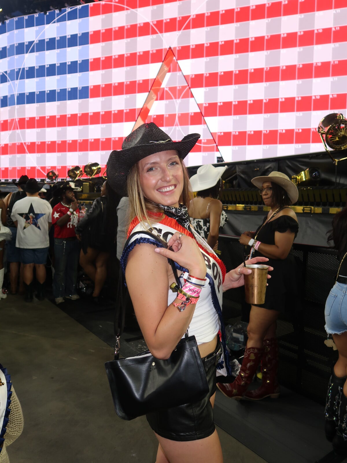 Concertgoer wearing a black Caitie G bag with a western outfit