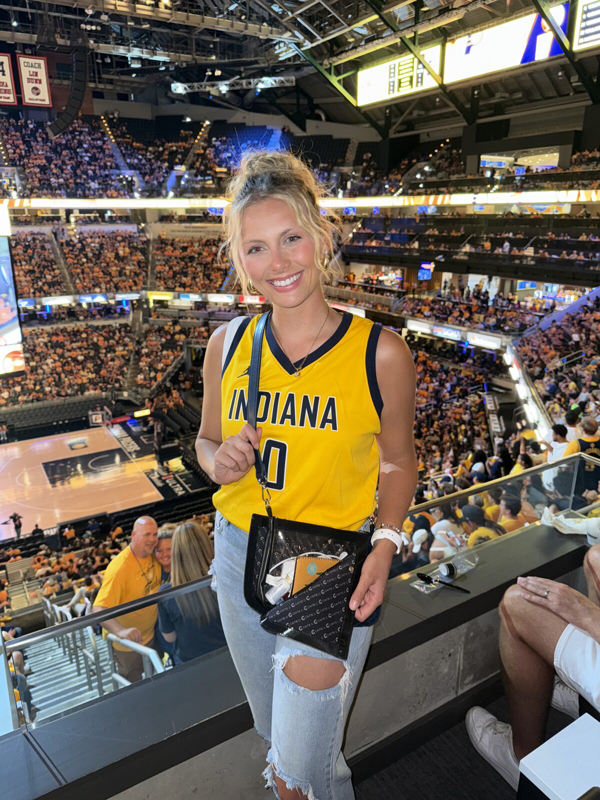 Pacers fan wearing a blue Caitie G bag in the arena